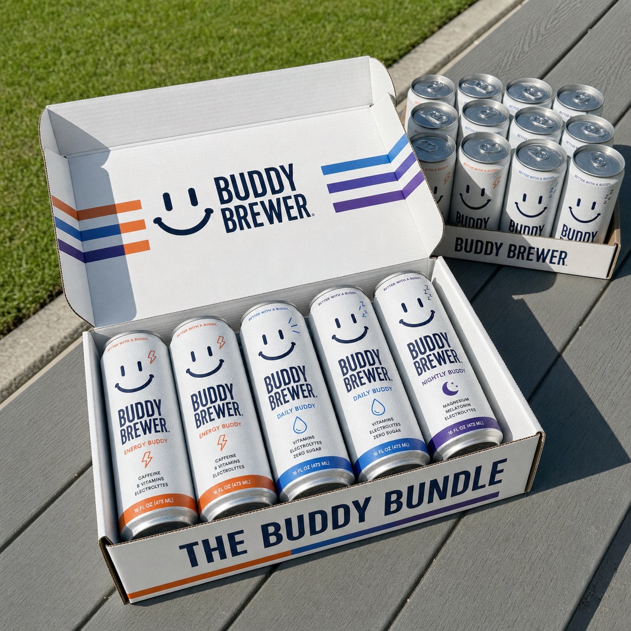 An open Buddy Bundle case of Morning, Daily, and Nightly Buddy cans on a sunny patio table